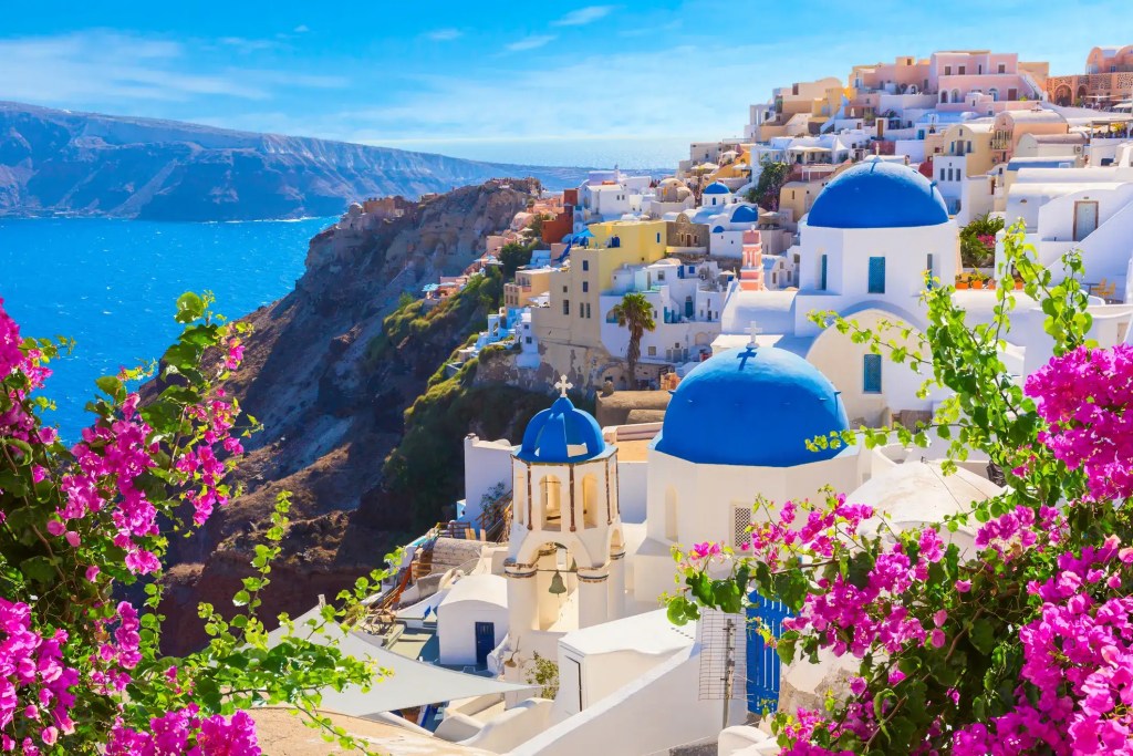 Santorini Greece view with blue domes and Mediterranean sea.
